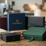 Custom luxury rigid gift boxes displaying gold foil, matte, and gloss lamination finishes for high-end brands.