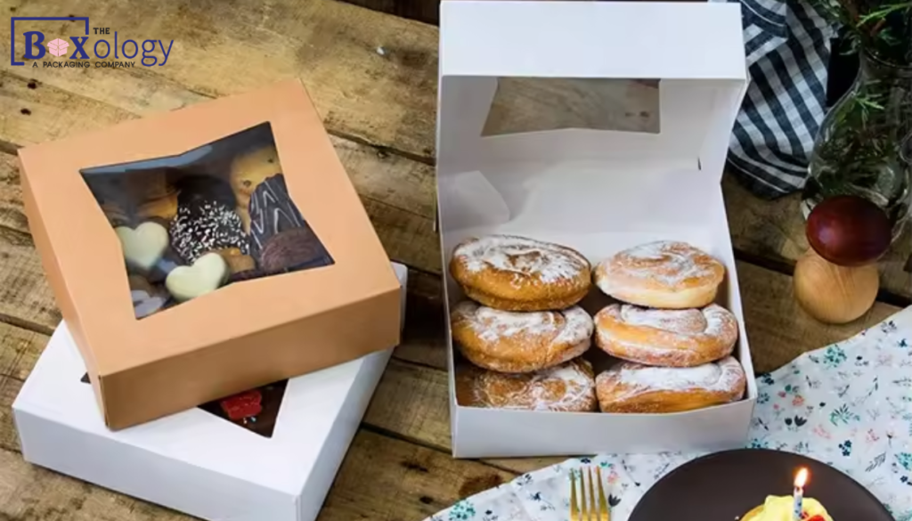 Custom cardboard bakery boxes with clear window displaying decorated gourmet cookies