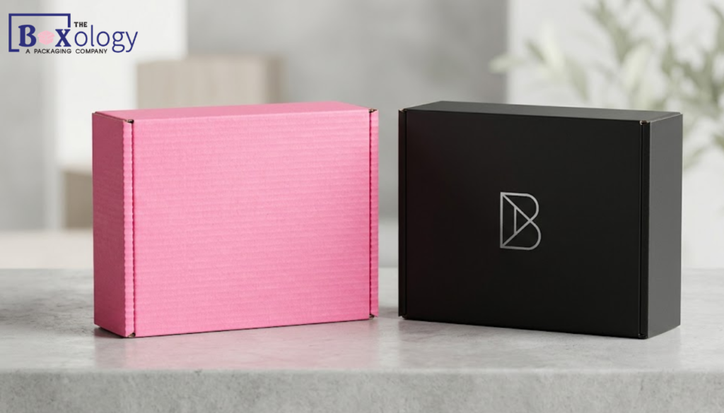 5 10 - Mailer Boxes Packaging Solution Pink corrugated boxes contrasted next to custom black mailer boxes.