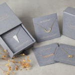Close up view of custom magnetic rigid boxes USA manufacturing details showing thick greyboard core and deep blue premium textured paper wrapper with gold foil stamped logo.